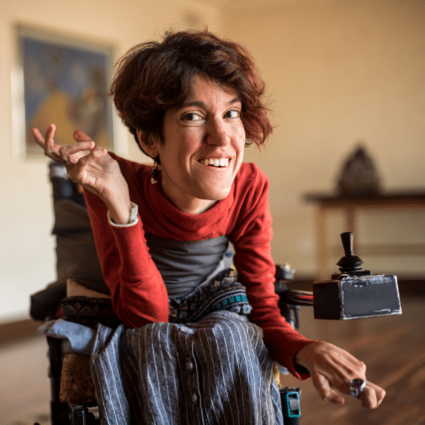 A smiling person on a wheelchair.